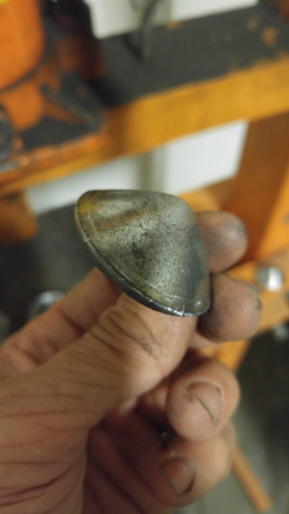 The formed steel cap, held in hand