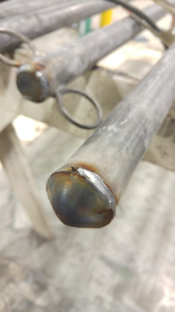 A support pole end capped and welded