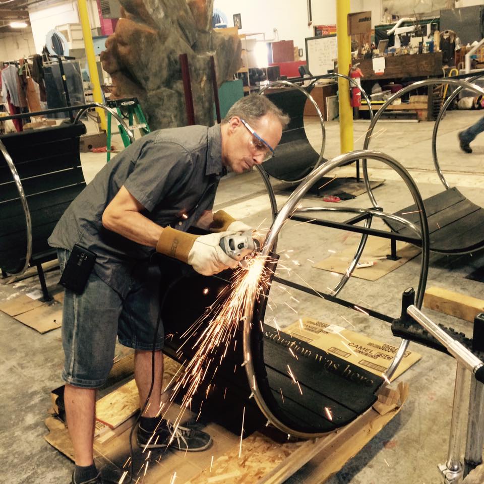Grinding a stainless hoop chair in the shop, sparks flying