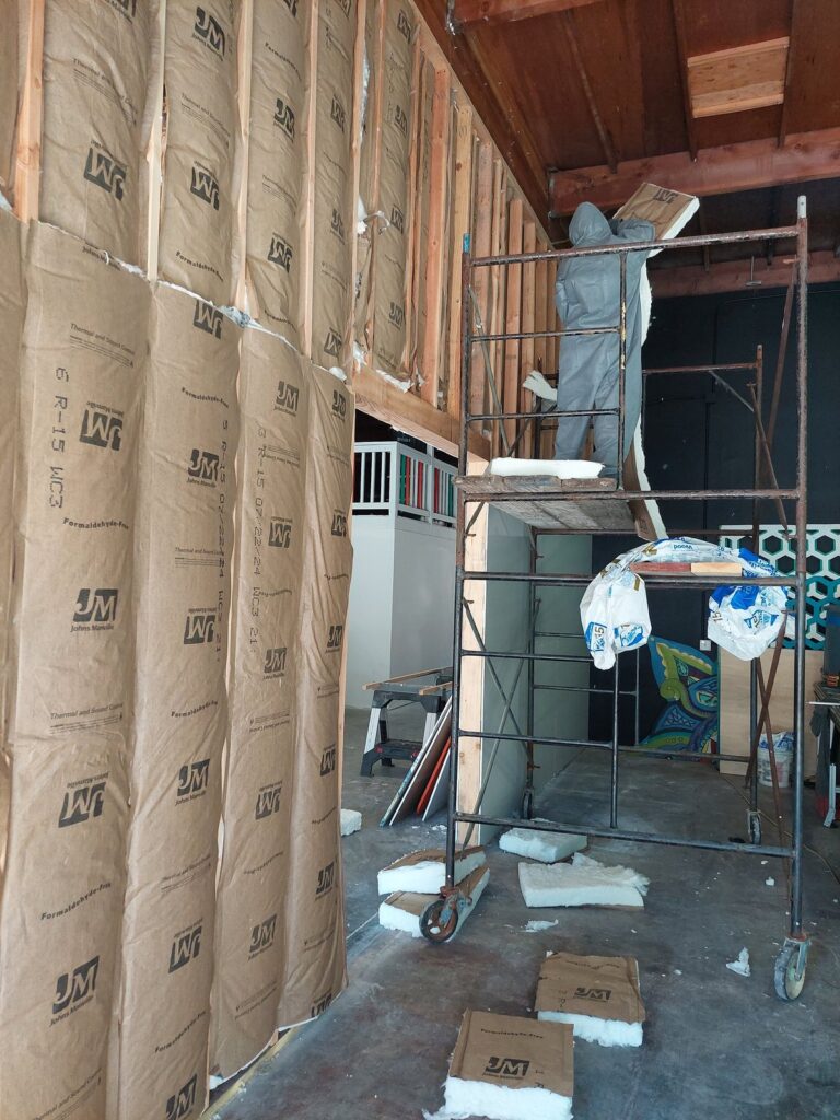 The Great Wall of Silence under construction: staggered stud framing with insulation and vapour barrier between the two faces