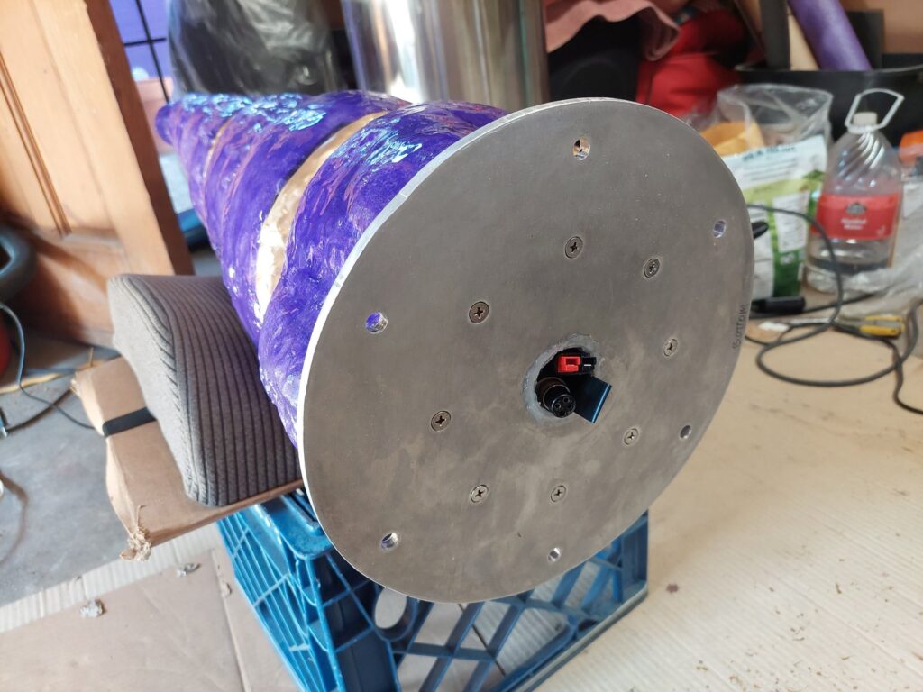 The base of the horn: a machined aluminum disc bolted around its perimeter, with a keyed electrical connector recessed at the center